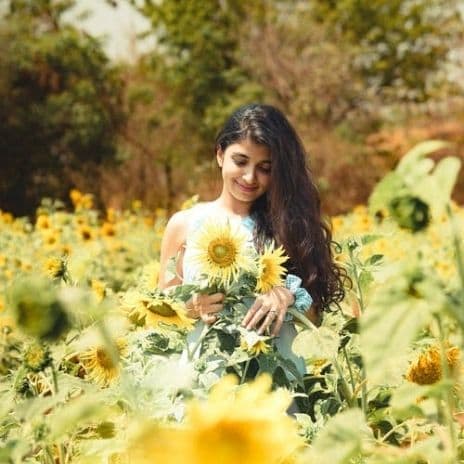 Girl in field with flowers